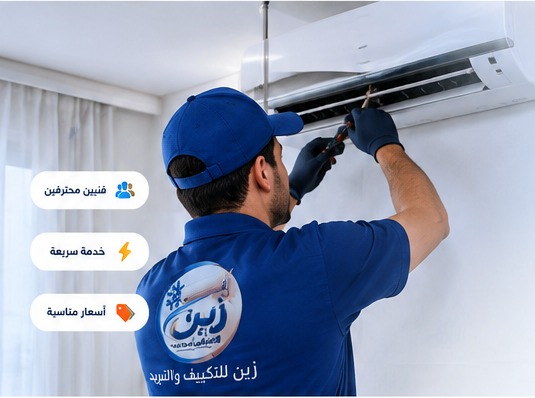 فني تكييف يقوم بصيانة مكيف
